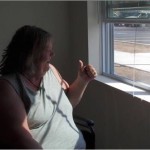 Cindy Grill signals the movers as they pull away